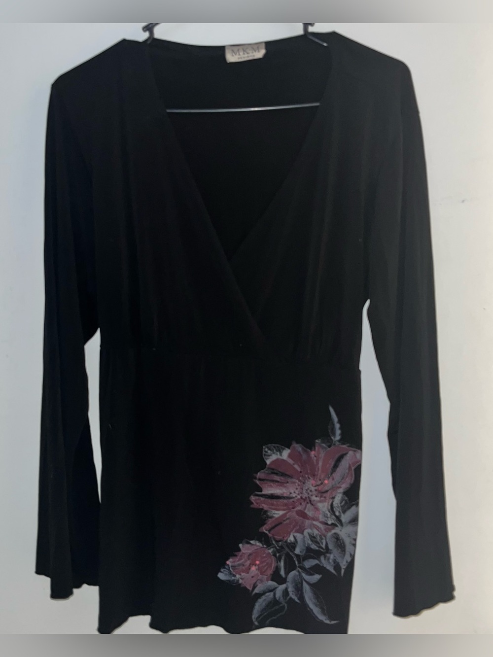 Black Long-Sleeve Wrap-Style Top with Pink Floral Accent